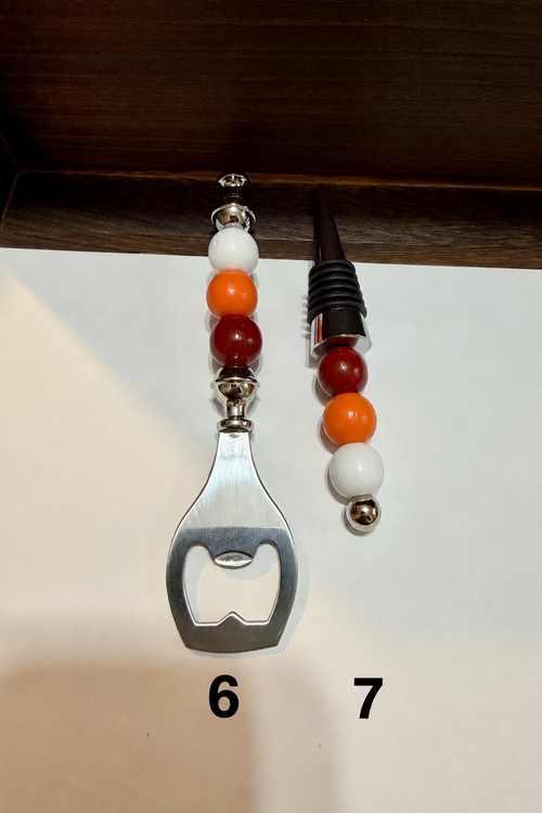 A bottle opener and a wine cork with decorative wooden beads on the handles