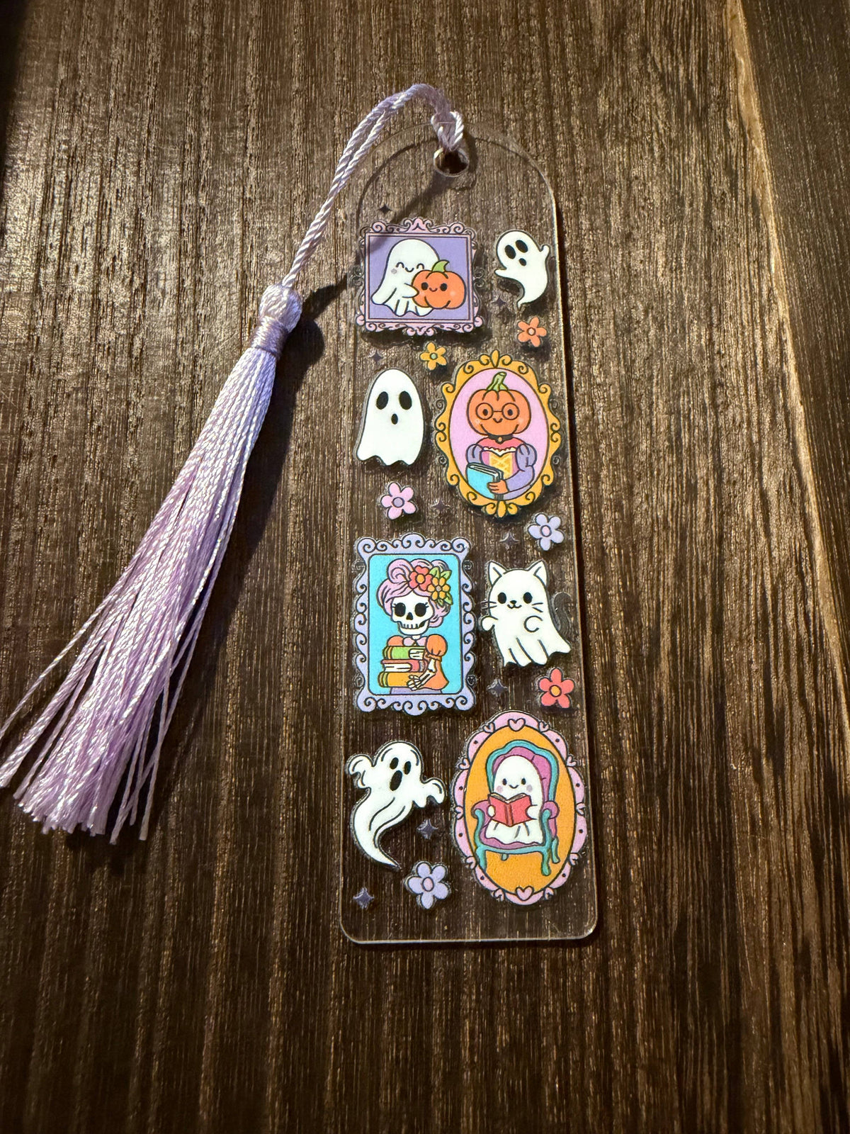 Handmade Halloween acrylic bookmark with a ghostly picture design.  Includes an adorable cat ghost on the design and a coordinating lavender tassel.