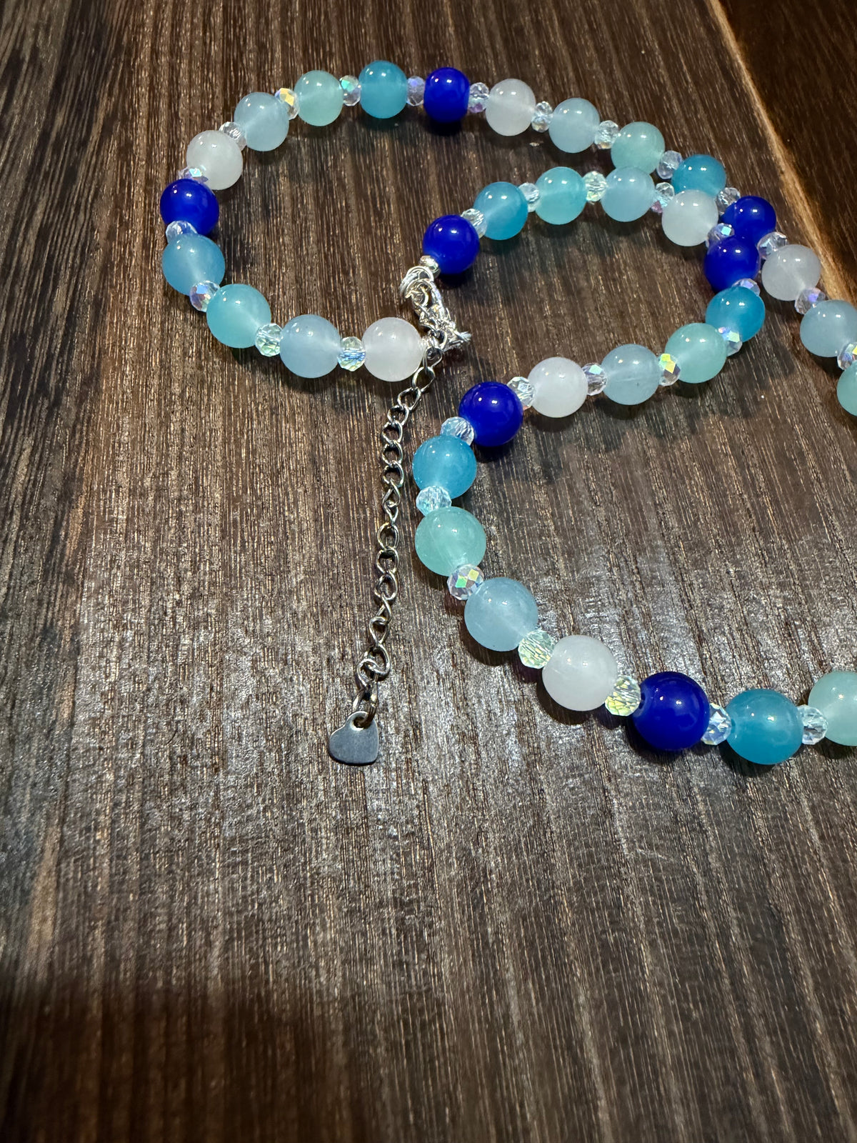 close up of the heart dangle on the extender chain as well as the sparkle of the faceted Austrian glass spacer beads